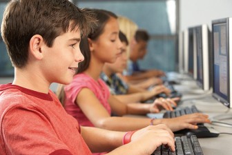 24489821 - elementary students working at computers in classroom